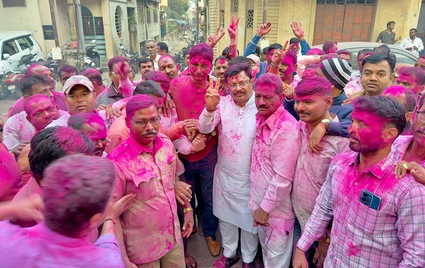 KMT employees celebrate by throwing flowers at Shiva temple